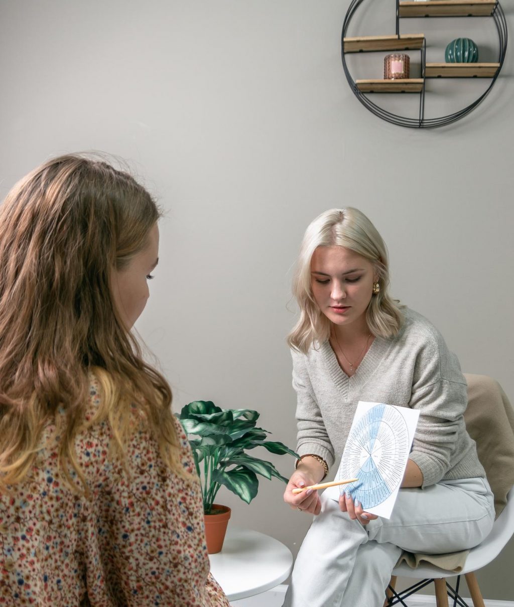 young-girl-student-psychologist-shows-wheel-emotions-client